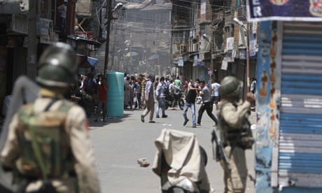 Protesters throw stones at Indian police during a protest in Srinagar