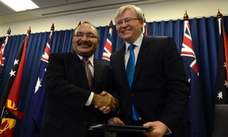 Prime Minister Kevin Rudd (right) and Papua New Guinea Prime Minister Peter O'Neill shake hands after signing an agreement to deal with asylum seekers in Brisbane.
