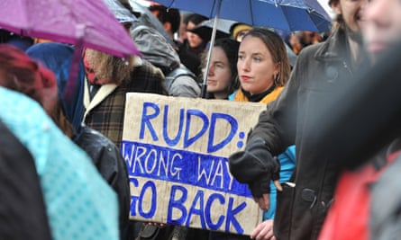 A protester holds a placard in the rain during a protest against the Australian Government asylum seeker policy in Melbourne on July 20, 2013.