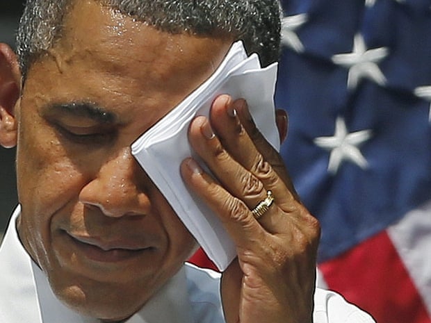 President Barack Obama wipes perspiration from his brow during an ambitious speech about climate change under a steaming hot sun at Georgetown University in Washington.