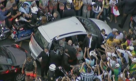 The pope's car is mobbed by well-wishers after taking a wrong turn on the road from the airport.