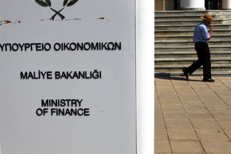 An elderly man walks outside the Ministry of Finance during a meeting between Cyprus' financial minister and central bank government and officials from the European Commission, European Central Bank and the International Monetary Fund in Nicosia, Wednesday, July 17, 2013.