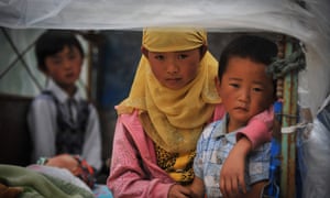 Children who have been displaced by the recent earthquake are photographed at a makeshift camp in Shendu in Minxian County, China.  The 6.6-magnitude earthquake that struck on Monday is thought to have left around 100 dead.