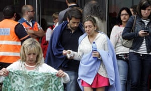 People mourn outside the Cersia building where relatives of the train crash victims are being looked after in Santiago de Compostela. The crash is thought to be Spain's worst train accident in four decades with the death toll rising to 78, with 130 others injured.