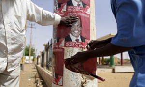 Supporters of the Malian candidate Dramane Dembele stick election posters at the former Sharia square in Gao, northern Mali. The presidential election is seen as crucial to reuniting a country divided by conflict during an 18-month crisis that saw French forces intervene to push out Islamist rebels from the north.