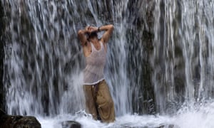 A man fasting during the holy month of Ramadan cools off in a waterfall in Islamabad, Pakistan.