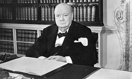 Winston Churchill sitting at his desk