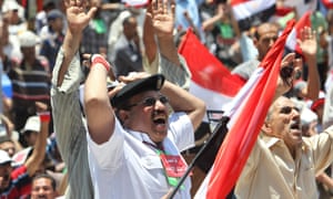 Protesters, including an Egyptian policeman, shout slogans during a protest in support of armed forces, at Tahrir square, Cairo, Egypt