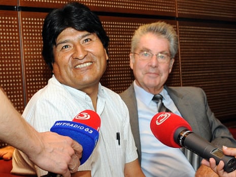 Bolivia's President Evo Morales, left, talks to reporters as he sits next to Austrian President Heinz Fischer at Vienna's Schwechat airport