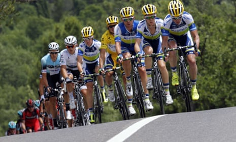 Overall leader's yellow jersey Australia's Simon Gerrans (C) rides with his teammates during the 228.5 km fifth stage of the 100th edition of the Tour de France cycling race on July 3, 2013 between Cagnes-sur-Mer and Marseille, southern France.  AFP PHOTO / JOEL SAGETJOEL SAGET/AFP/Getty Images