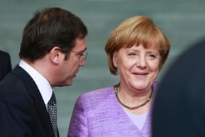Portugal's Prime Minister Pedro Passos Coelho  talks with German Chancellor Angela Merkel at an EU conference on Youth Unemployment in Berlin, July 3, 2013.