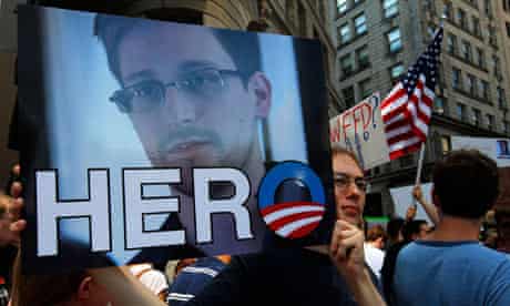 A demonstrator holds a photograph of Edward Snowden