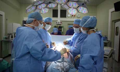 A surgeon and his theatre team at the Queen Elizabeth hospital in Birmingham