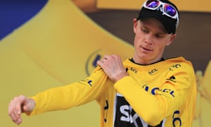 Chris Froome pulls on the yellow jersey