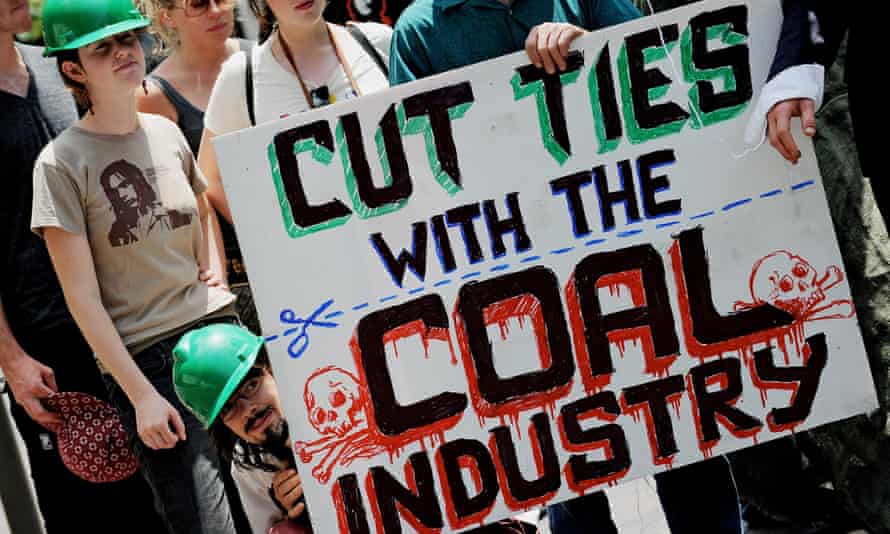 Enviroment activists display an anti-coal industry placard outside the New South Wales Parliament building in Sydney.