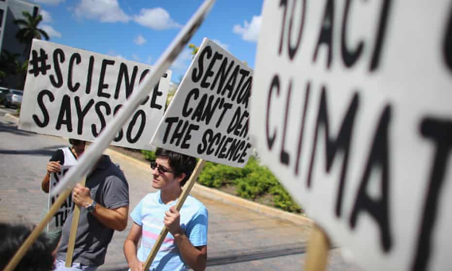 MIAMI, FL - AUGUST 13:  Alexius Marcano  and other protesters gather near the office of U.S. Sen. Marco Rubio