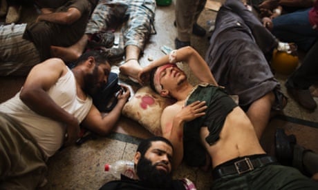 Wounded supporters lie on the floor of a makeshift hospital at Cairo's Nasr City district.