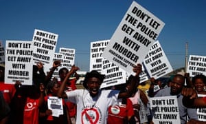 Demonstrators call for justice for the 34 mineworkers killed by police at Marikana