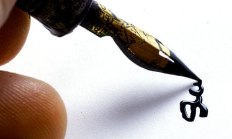 Someone signing a white piece of paper with a gold-tipped ink foundation pen