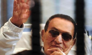 Former Egyptian President Hosni Mubarak waves to his supporters inside a cage in a courtroom at the police academy in Cairo, in this file picture taken April 13, 2013. REUTERS/Stringer/Files