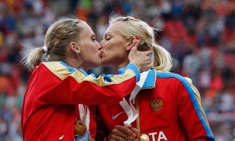 Ksenia Ryzhova kisses Yulia Guschina on the podium at the World Athletics Championships 