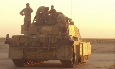 Chris Yates (left) on his tank in Afghanistan