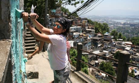 Woman painting a favela in Rio de Janeiro