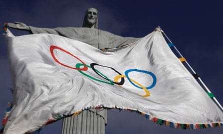 The Olympic Flag flies in front of "Christ the Redeemer" statue