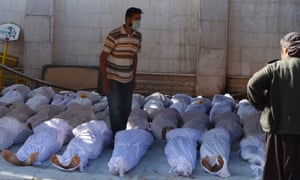 Syrian activists inspect the bodies of people they say were killed by nerve gas in the Ghouta region, in the Duma neighbourhood of Damascus, on 21 August, 2013.