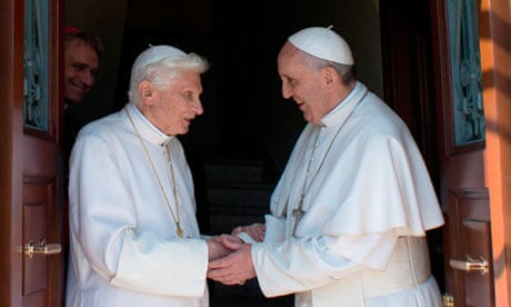 Former pope Benedict greets Pope Francis at the Vatican
