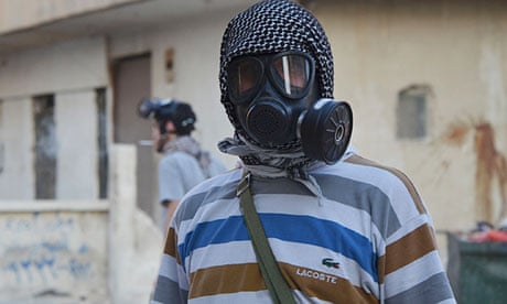 An activist wearing a gas mask in an area of Damascus where activists say chemical weapons were used