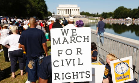 Marchers hold signs during the 50th anniversary of the 1963 March on Washington
