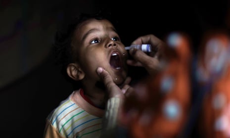 Pakistani health worker Shahida Akram, 41, gives a polio vaccine to a child, in a neighborhood in Islamabad, Pakistan, Wednesday, Jan. 30, 2013.  Some Islamic militants oppose the vaccination campaign, accuse health workers of acting as spies for the U.S. and claim the polio vaccine is intended to make Muslim children sterile. Pakistan is one of the few remaining places where polio is still rampant. (AP Photo/Muhammed Muheisen)