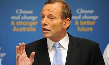 Opposition leader Tony Abbott speaks during a press conference in front of his new campaign slogans