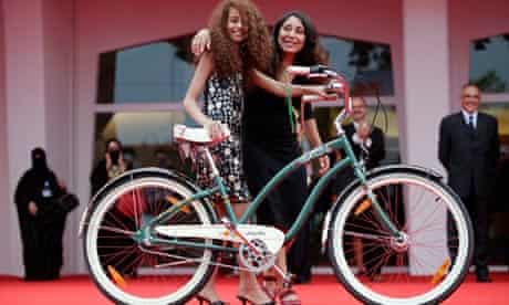 Wadjda director Haifaa al-Mansour and actress Waad Mohammed pose with a bicycle 
