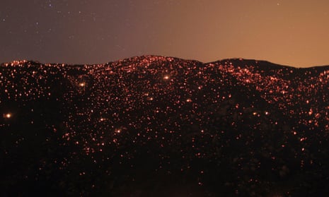 A smouldering mountainside is seen under the stars at the Silver Fire near Banning, California.