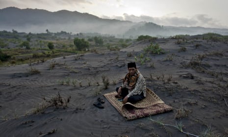 A muslim man sits on 'sea of sands' as he waits for Eid al-Fitr prayer at Parangkusumo Beach, Indonesia.