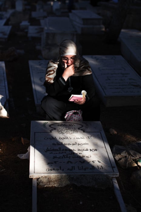 A Palestinian woman visits the grave of her relatives on Eid al-Fitr, at the cemetery of the West Bank city of Ramallah.