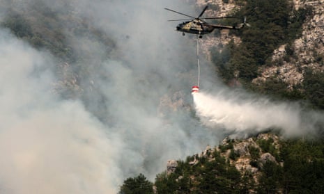 A Bosnia and Herzegovina armed forces' helicopter is seen dropping water while on a firefighting mission near the Southern-Bosnian town of Jablanica.