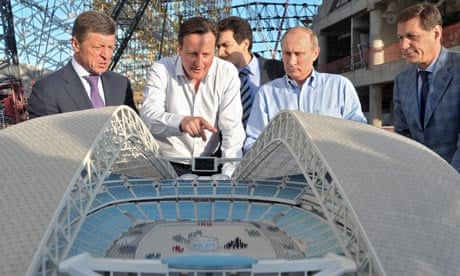 David Cameron and Vladimir Putin examine a model of a stadium for the 2014 winter Olympics