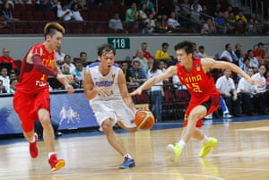 Taiwan's Lin Chih-Chieh (C) is guarded by China's Zhou Peng (R) and Sun Yue during their quarterfinals basketball match at the FIBA Asia Championship in Manila, Philippines. Photograph: Romeo Ranoco/Reuters