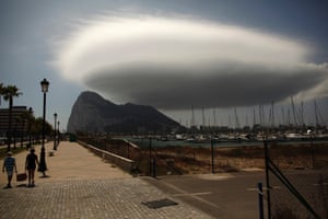 Stormy weather ahead: People walk along a street in front of the British territory of Gibraltar (rear), next to the border with southern Spain. Spanish Prime Minister Mariano Rajoy said he hoped for dialogue with Britain soon regarding Gibraltar, but added that until talks took place his government would continue to consider unilateral measures to defend Spanish interests. Photograph: Jon Nazca/Reuters
