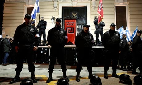 Members of the extreme-right Golden Dawn party stand around a stage during a gathering in Athens