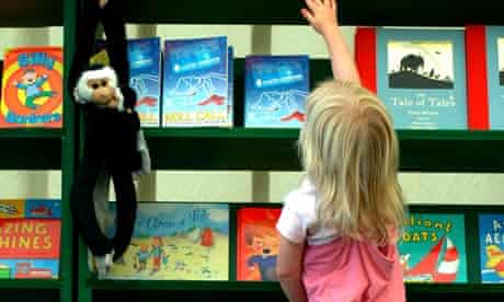 A YOUNG GIRL REACHES UP FOR A BOOK 