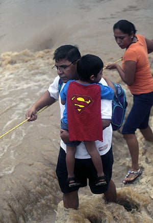 mexico floods: Residents wade through a flooded street