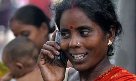 MDG :  Indian slum dweller uses mobile phone in Kolkata