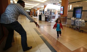 A child runs to safety as armed police hunt gunmen who went on a shooting spree at Westgate shopping centre in Nairobi.