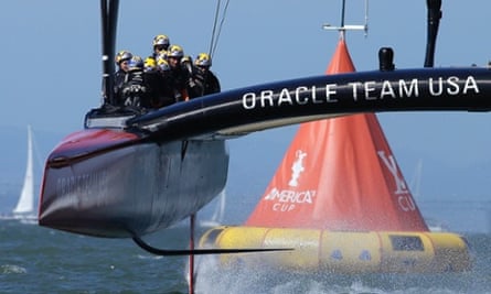 Oracle Team USA crosses the finish line during the 18th race of the America's Cup sailing event against Emirates Team New Zealand.