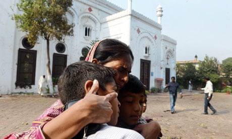 A Pakistani Christian woman embraces children