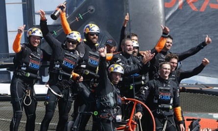 Oracle Team USA crew, including skipper Jimmy Spithill, second from left, and tactician Ben Ainslie, front centre, celebrate after winning  the America's Cup.